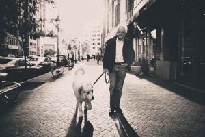 elderly man walking dog