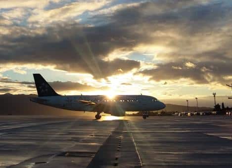 a plane an an airport at sunset